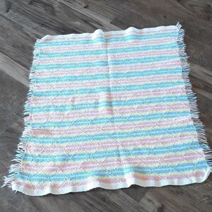 Beautiful pink, blue, yellow, and white 36" X 32" fringed blanket